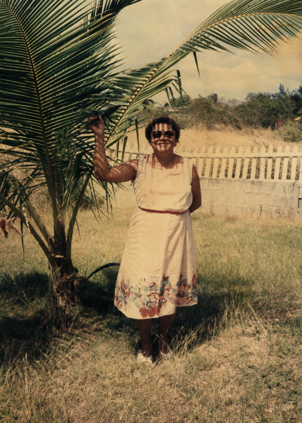 Maria's maternal grandmother, Marguerite Tobierre-Willie, standing beside a palm tree